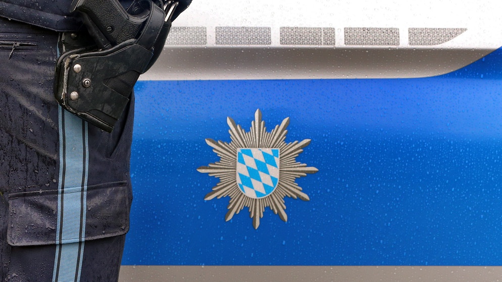 ARCHIV - 15.03.2019, Bayern, Kempten: ILLUSTRATION - Ein Polizist mit Handschellen und einer Pistole am Gürtel steht vor einem Streifenwagen. Am 18.03.2019 wird die bayerische Kriminalstatistik 2018 bekannt gegeben. (zu dpa: «Razzia wegen Kinderpornografie in Niederbayern») Foto: Karl-Josef Hildenbrand/dpa +++ dpa-Bildfunk +++ | Bildquelle: dpa-Bildfunk/Karl-Josef Hildenbrand
