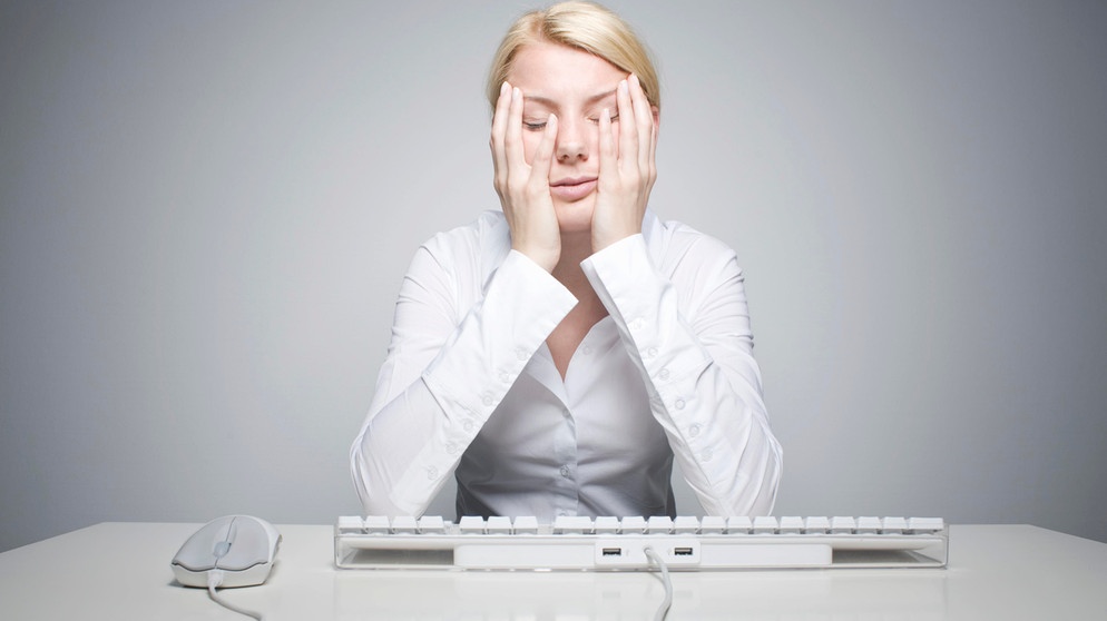 alpha-thema Gespräch: Die erschöpfte Gesellschaft - die erschöpfte Frau | Junge blonde Frau sitzt verzweifelt vor einer Computertastatur | Bildquelle: picture alliance / imageBROKER | photorevolution