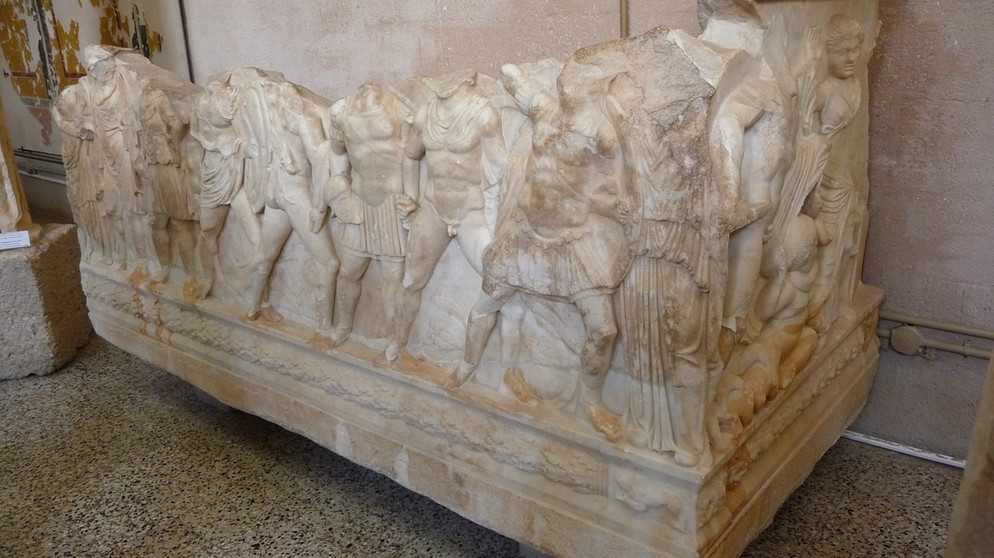Sarkophag eines jugendlichen Athleten, auf dem die Abreise der Sieben gegen Theben dargestellt ist, im Museum der archaeologischen Ausgrabungsstaette des antiken Korinth, Peloponnes, Griechenland. | Bildquelle: picture-alliance/dpa